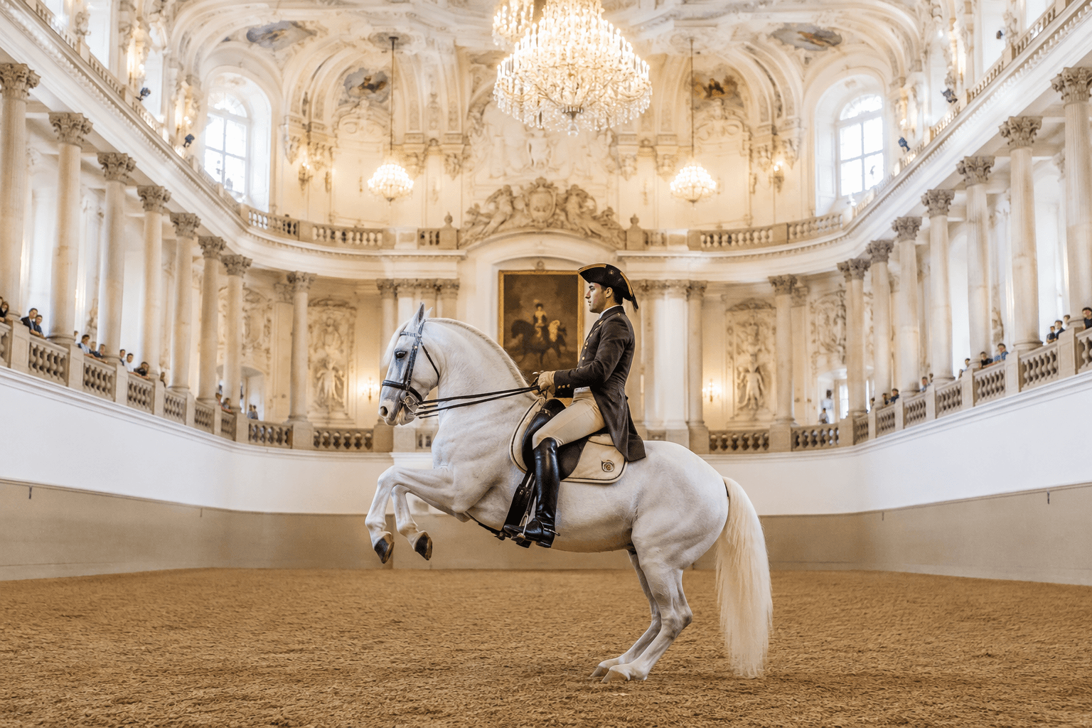 Lipizzaner horse and rider performing classical dressage inside the historic Spanish Riding School in Vienna.